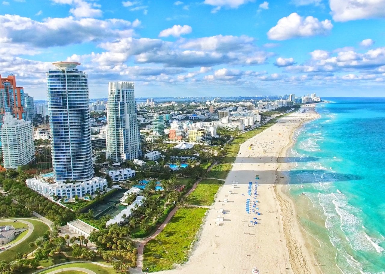 Tall buildings alongside a sandy beach.