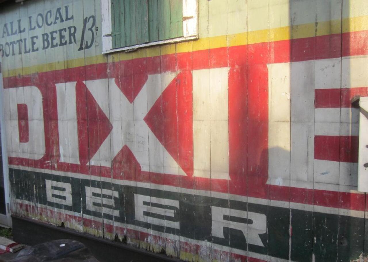 The Dixie Beer logo on the side of a building in New Orleans.