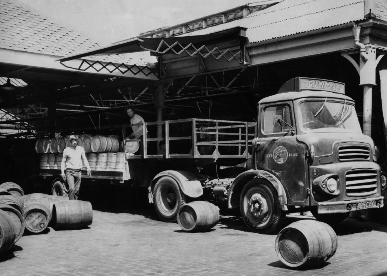 Two workers loading kegs on a truck at the Truman Brewery in London.