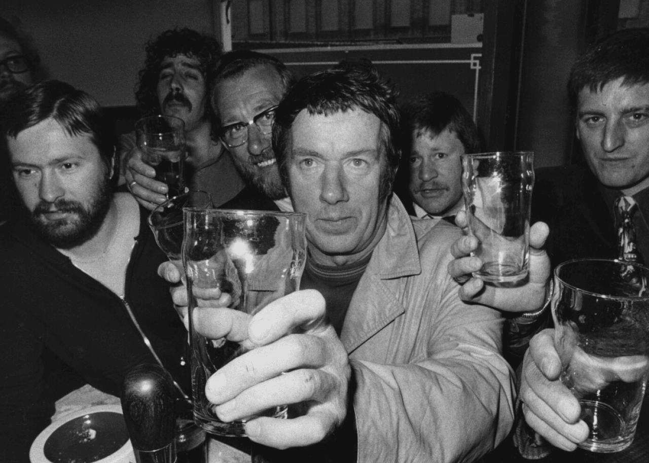 Pub patrons wait for their pint glasses to be refilled.