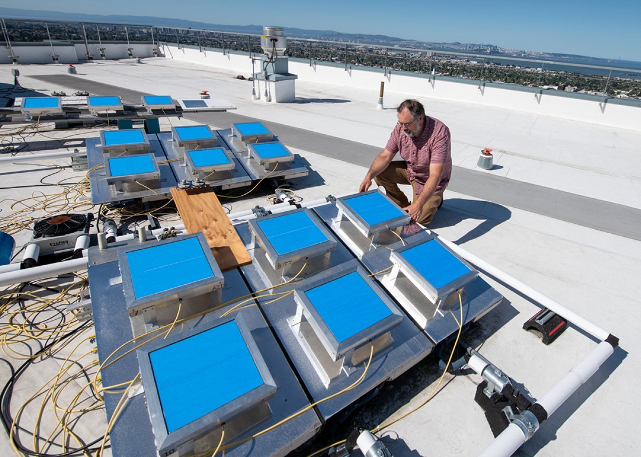 Howdy Goudey checks a testing apparatus that measures passive radiative cooling film on a roof at Lawrence Berkeley National Laboratory in Berkeley, California.