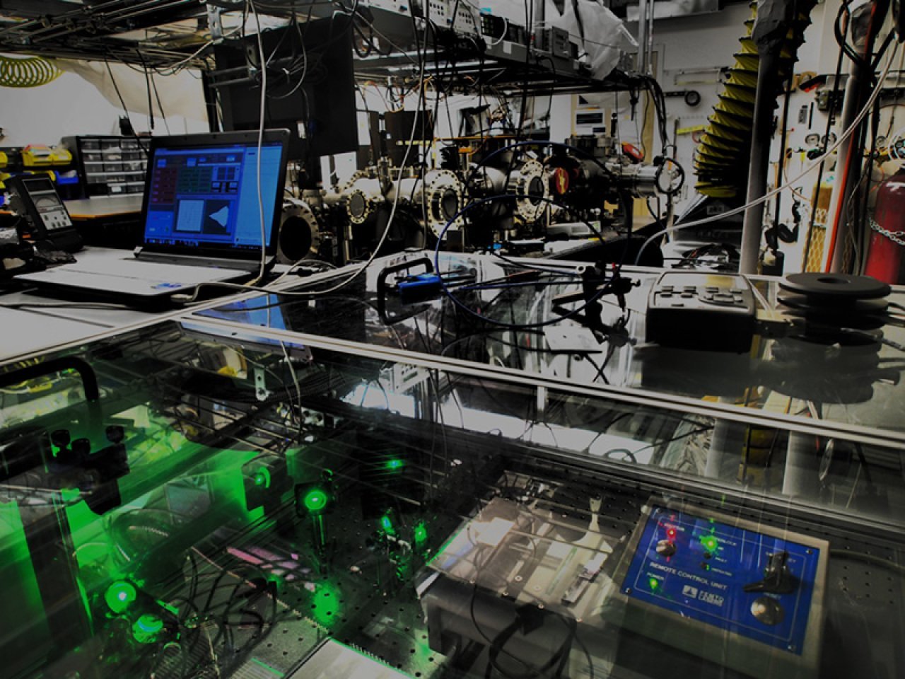 Stephen Leone’s lab full of equipment like vacuum chambers, vibration-suppression tables, lenses and crystal elements that shift, split and recombine laser beams, compress or expand light pulses and impart tiny delays into when pulses reach samples and detectors.