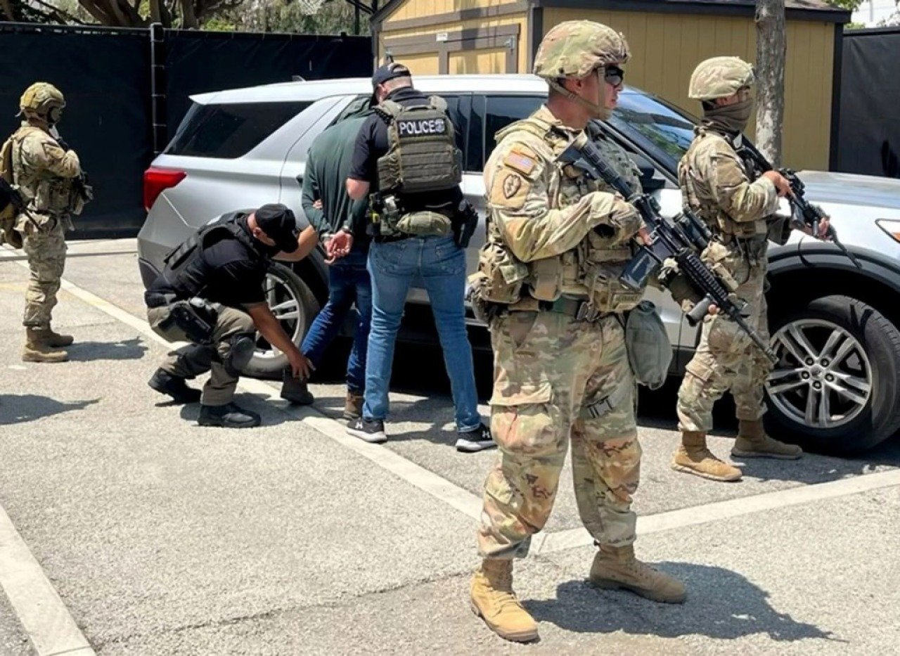 National Guard troops stand guard as federal agents make an immigration arrest in Los Angeles.