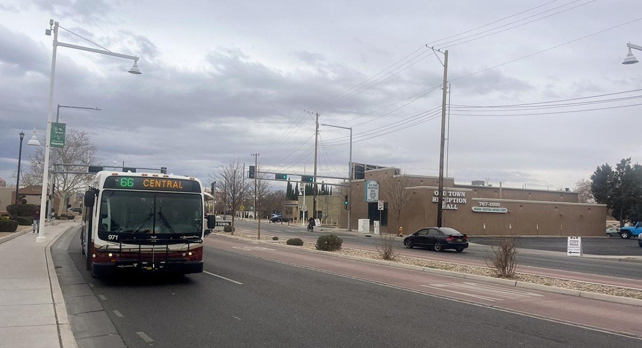 Bus driving on road toward viewer with destination 