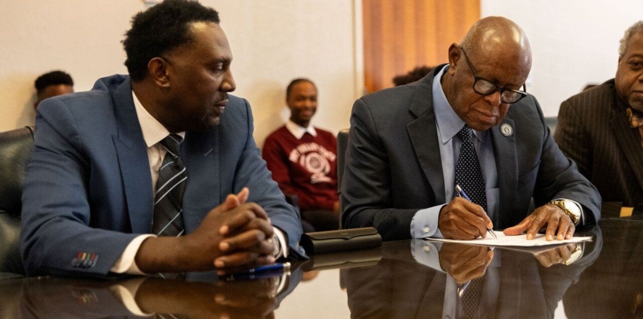 Imola Automotive USA CEO Rodney Henry, left, looked on as Dr. Isaac Crumbly, of Fort Valley State University in Georgia, signed an agreement in 2024 to collaborate on science and workforce development.