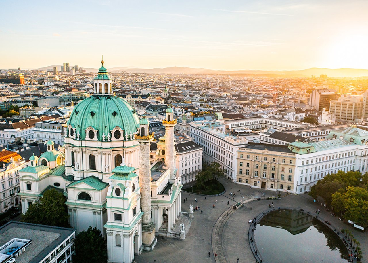 Aerial view of the St. Charles Church area in Vienna, Austria during sunrise.
