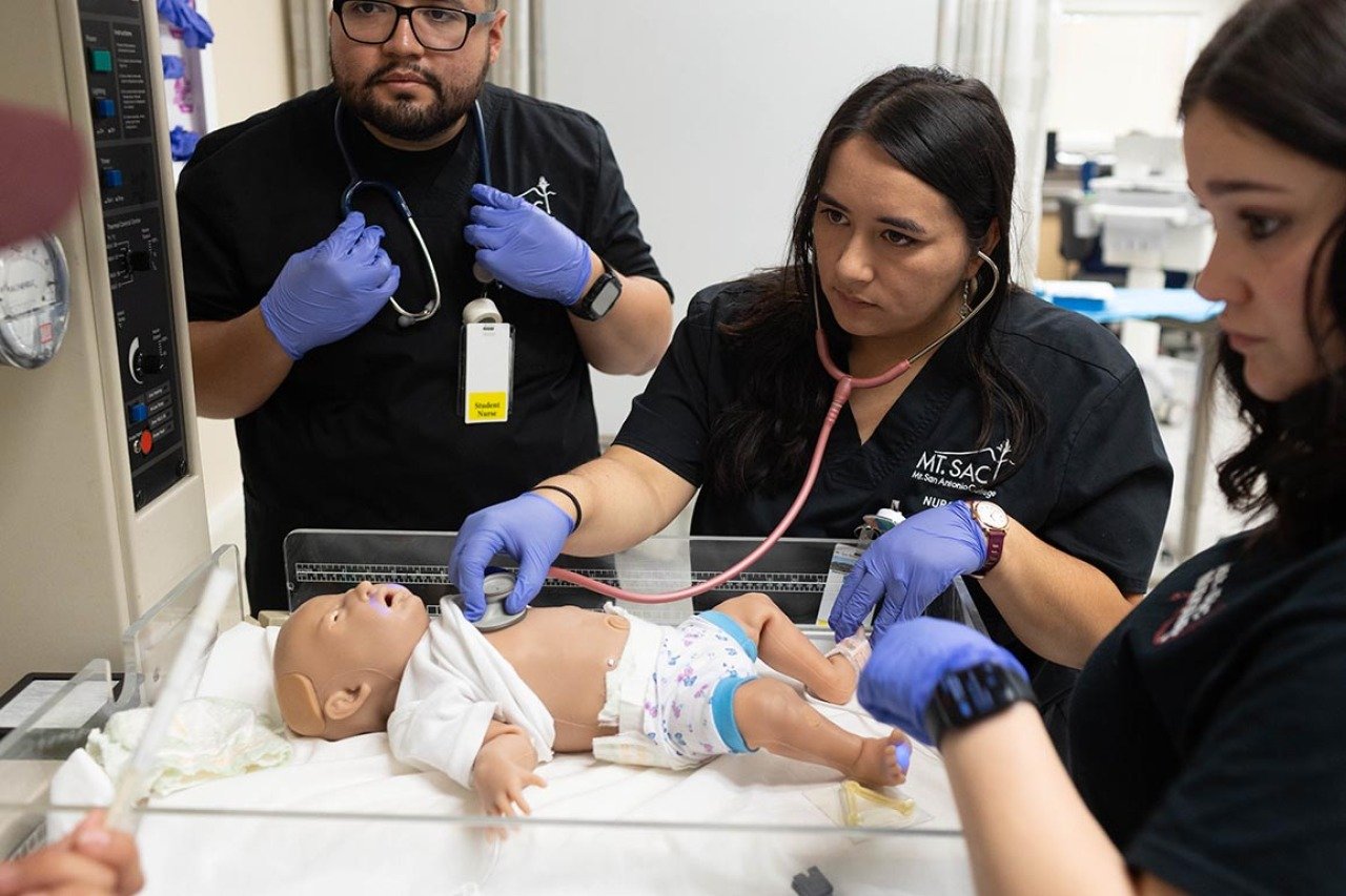 Students practice how to do an APGAR assessment on a simulated newborn baby at Mt. San Antonio College campus. 