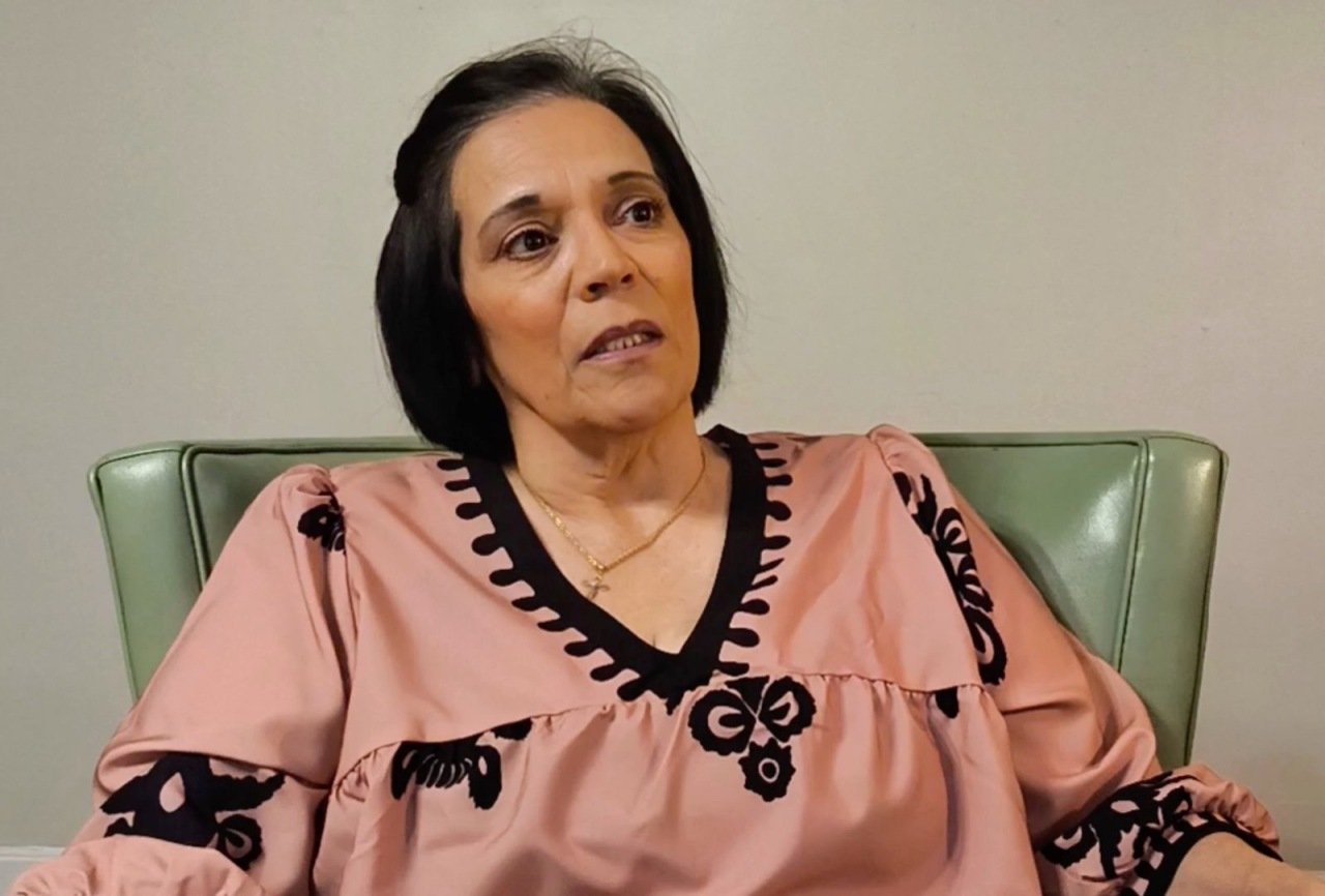 Former teacher Amy Franco, wearing a pink shirt with black detailing, speaks during an interview.   