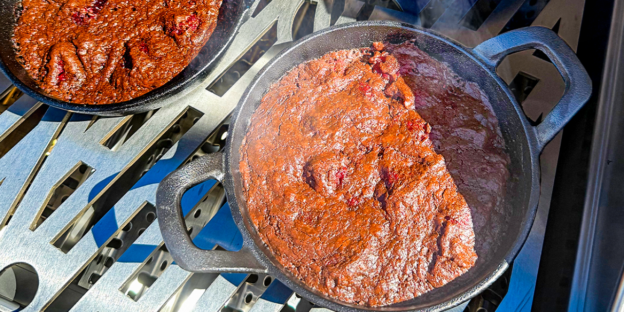 Raspberry brownies freshly baked in an iron skillet.