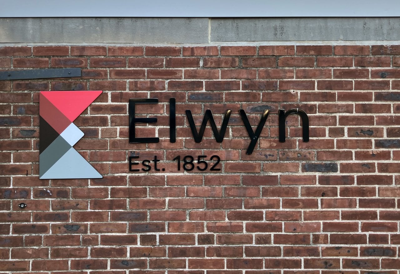 Exterior view of brick wall with signage at Elwyn in Philadelphia, Pennsylvania.