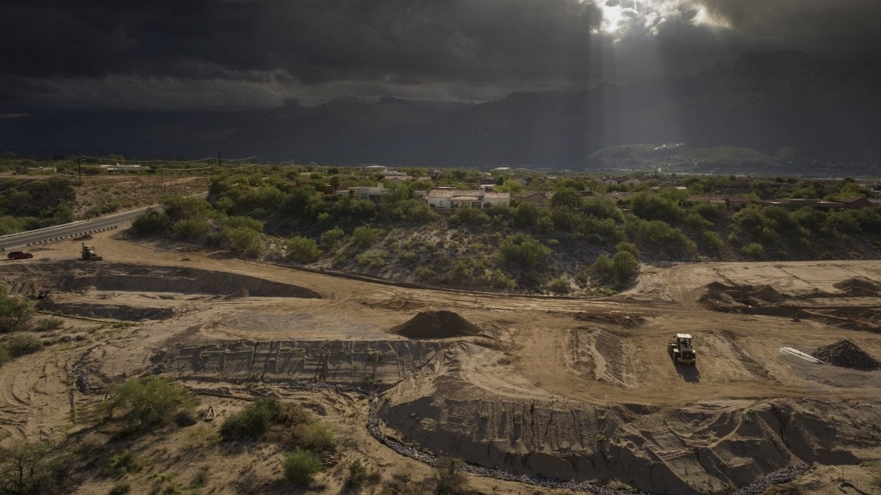 Heavy equipment kicks up dust at a construction site near Tucson, Arizona. 