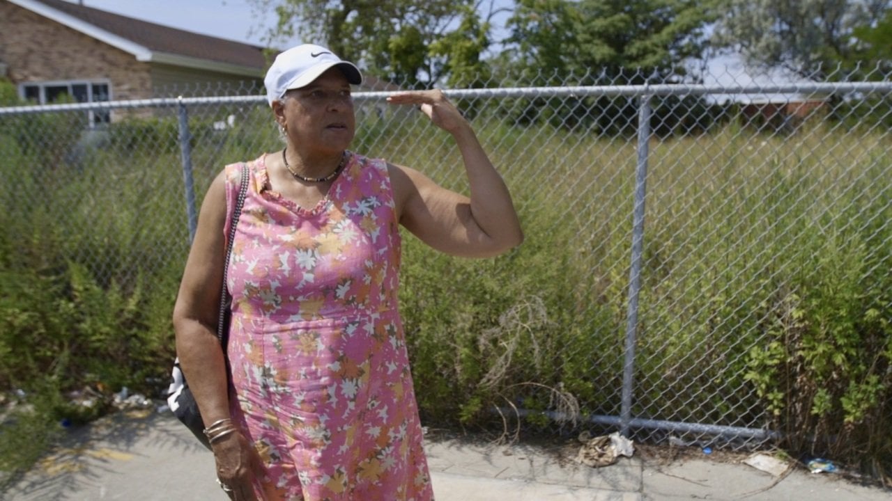 Longtime resident Sonja Webber-Bay explaining how high how high the water reached on the streets of Edgemere during Superstorm Sandy in 2012.