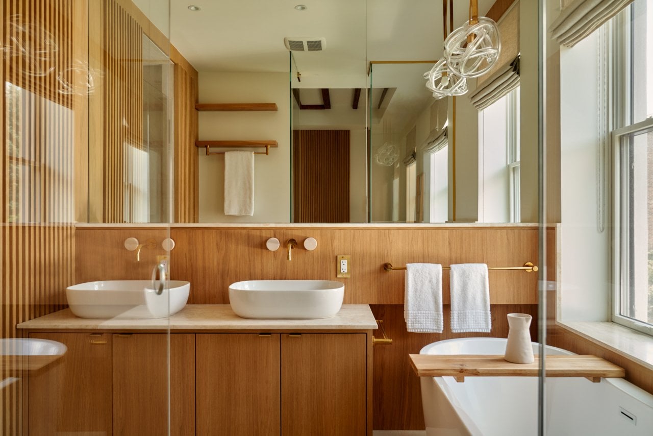 Interior of a modern bathroom with wall-mounted faucets.