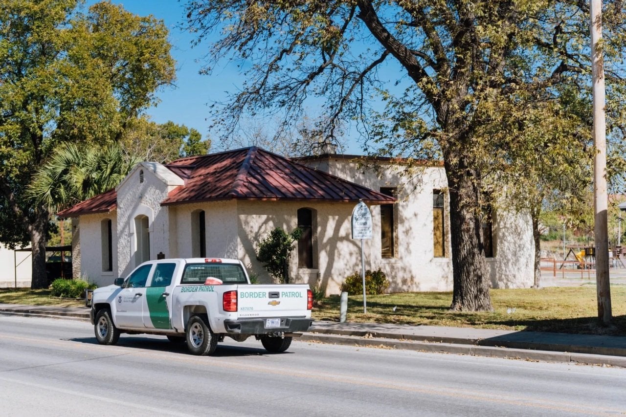 Border Patrol agents drive through a neighborhood in Kinney County, a rural county on the Texas-Mexico border. 