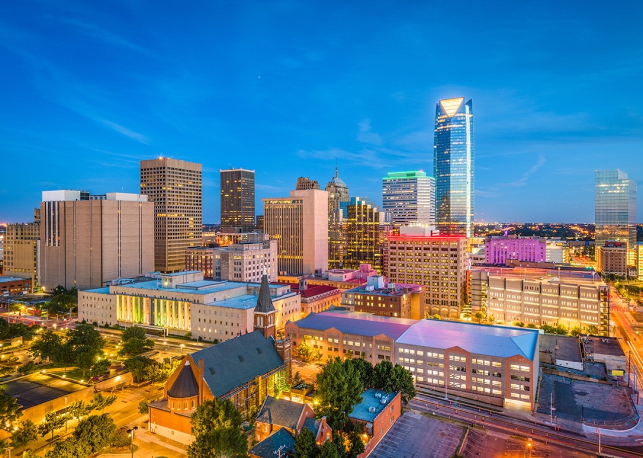 Aerial view of Oklahoma City's downtown skyline at twilight.