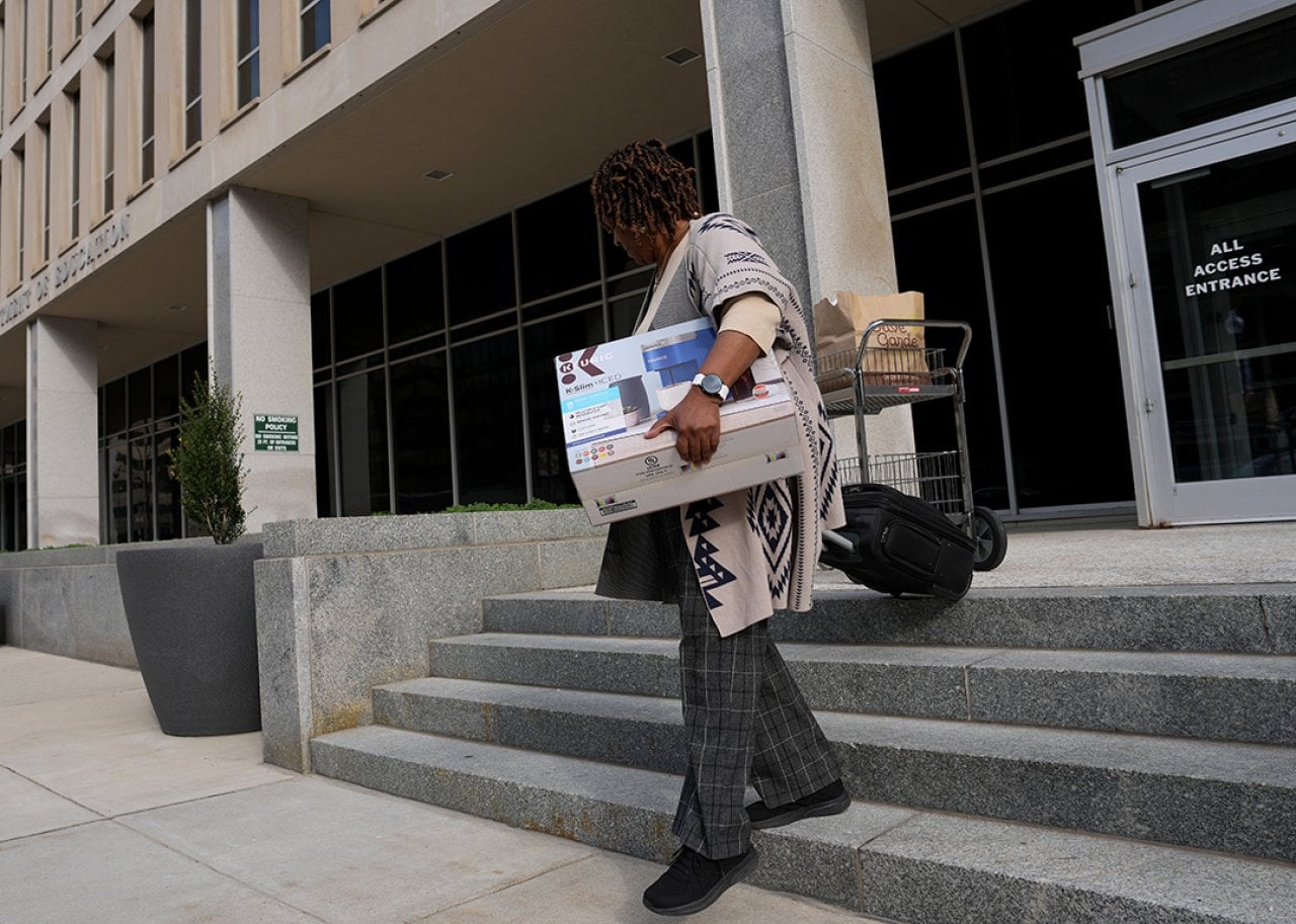 A US Department of Education employee leaving the building with their belongings on March 20, 2025 in Washington, DC.