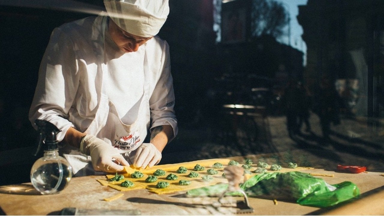 A chef preparing a ravioli pasta dish.