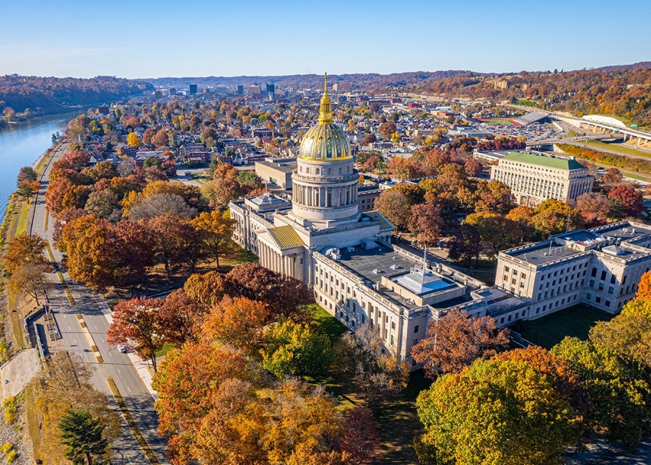 An aerial view of the West Virginia State Capitol Building and Charleston during fall.