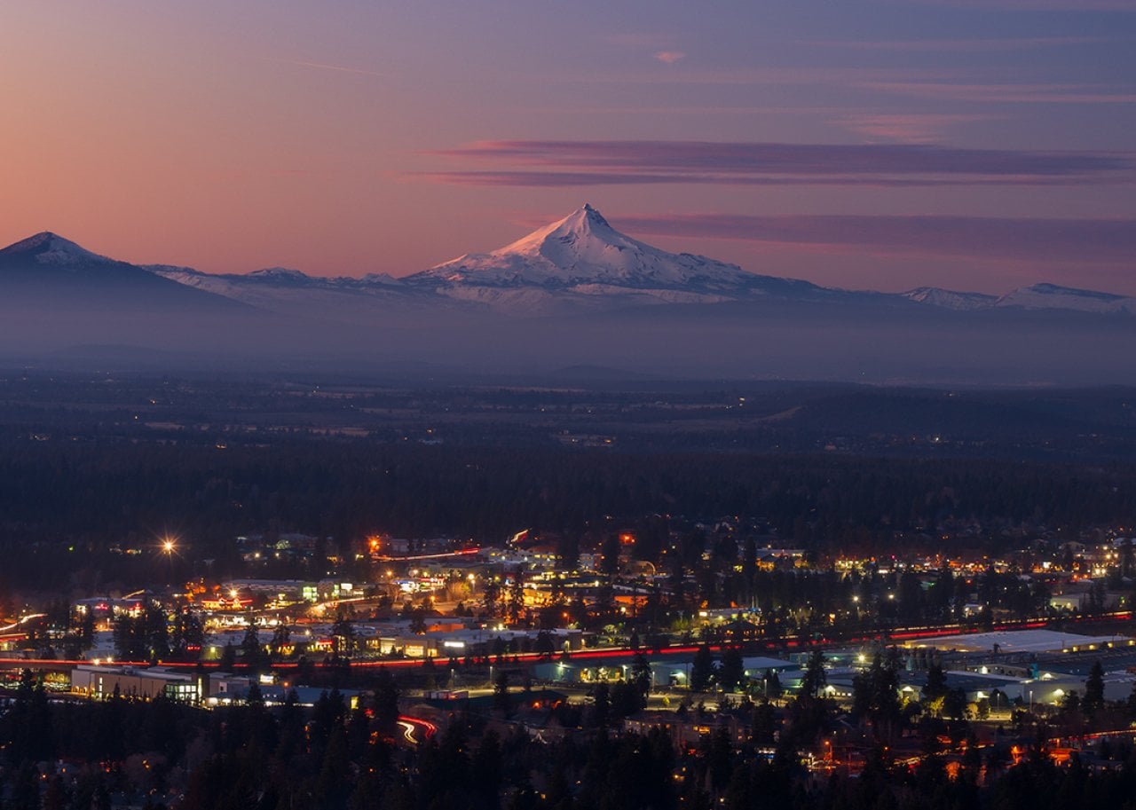 Bend, Oregon's cityscape with Mount Jefferson at sunset.