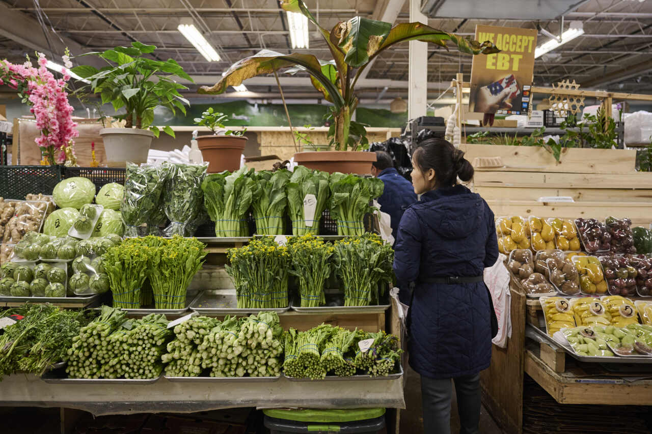 Lee Vang makes a sale at Hmong Village, an indoor marketplace in St Paul.