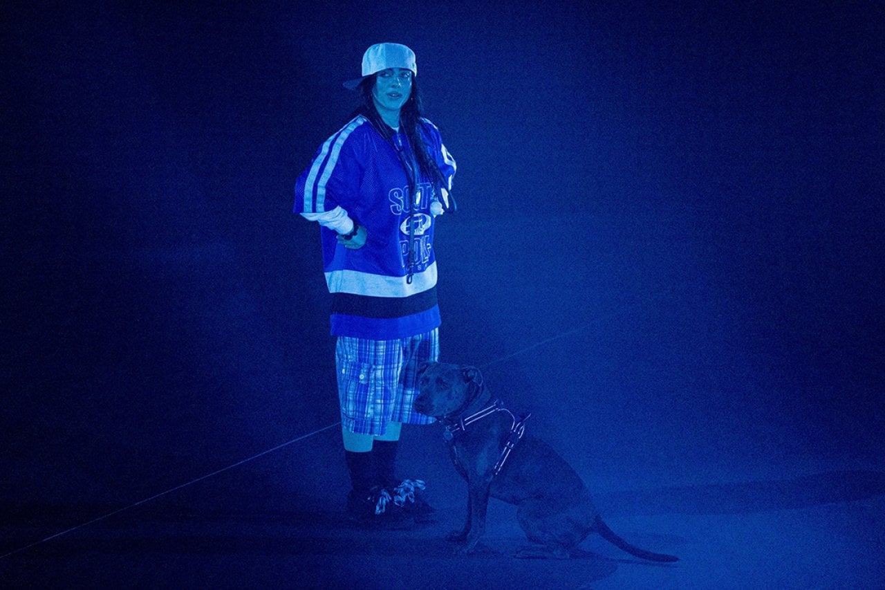 Billie Eilish on a stage with her dog as she hosts a listening party for her new album 'Hit Me Hard And Soft' at the Kia Forum on May 16, 2024 in Inglewood, California.