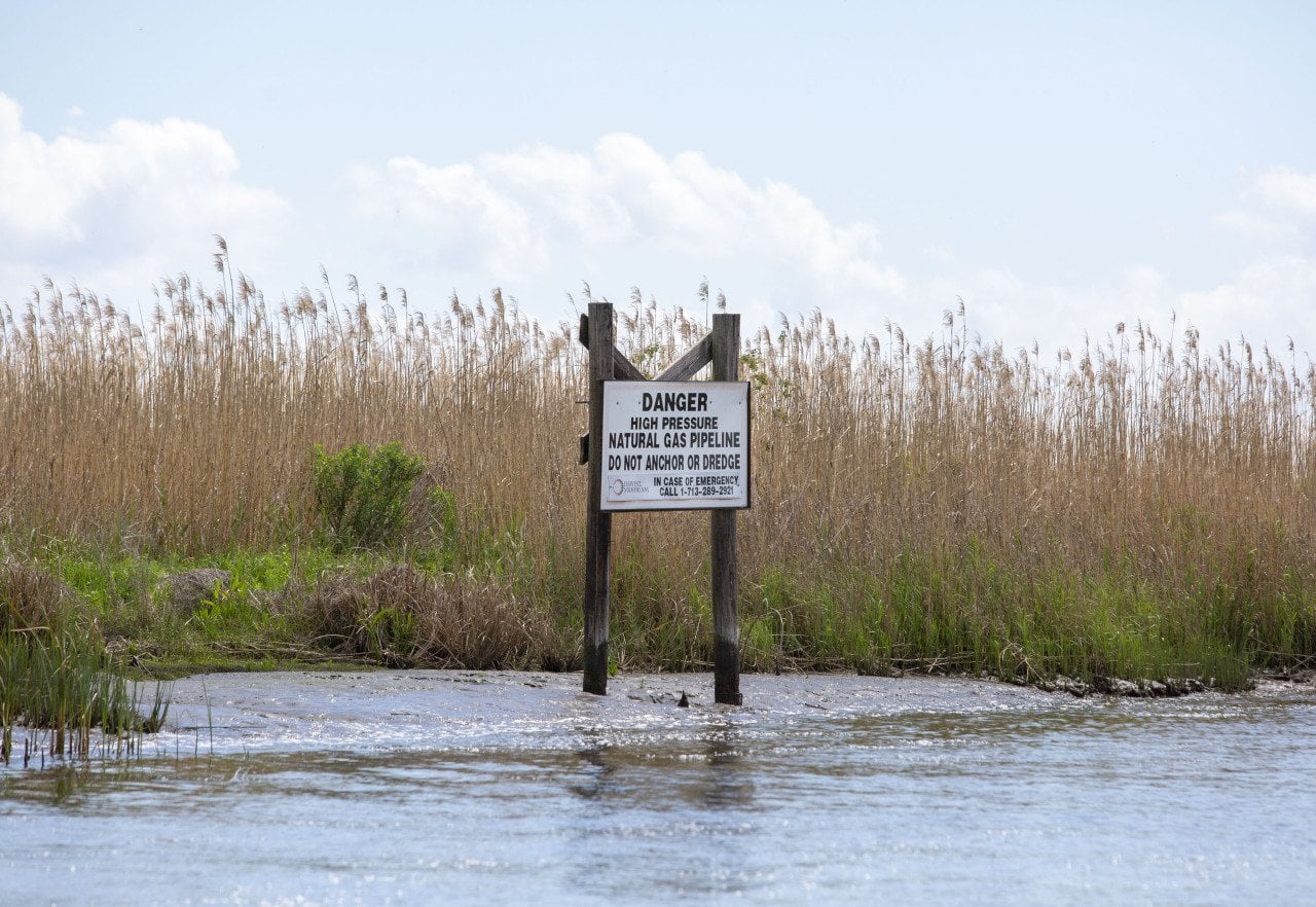 A sign warns of a natural gas pipeline on a canal north of Vermilion Bay on March 27, 2026.