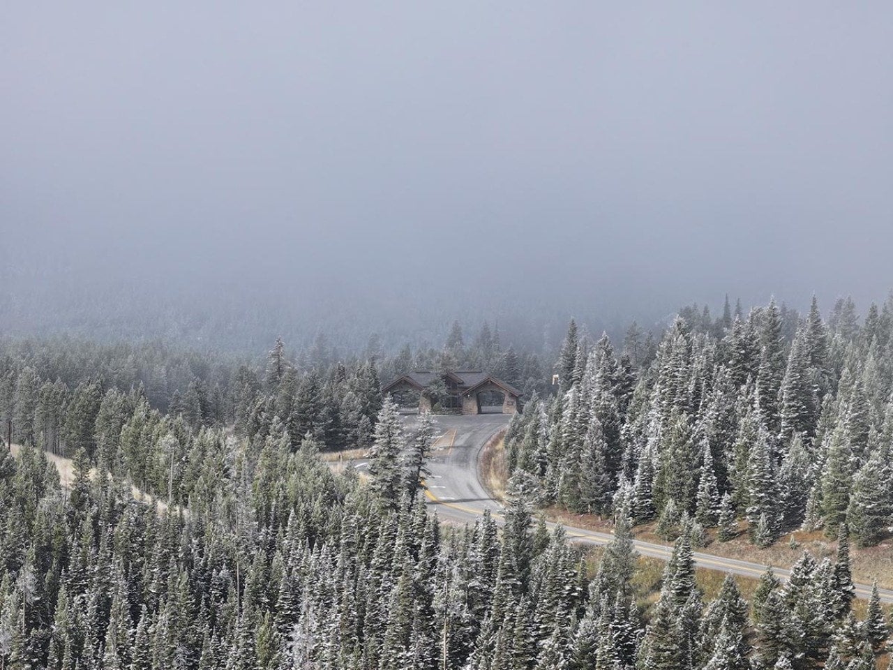 Fog descends on the entrance gate to the Yellowstone Club, a mountaintop enclave for the megarich, seen outside Big Sky, Mont.