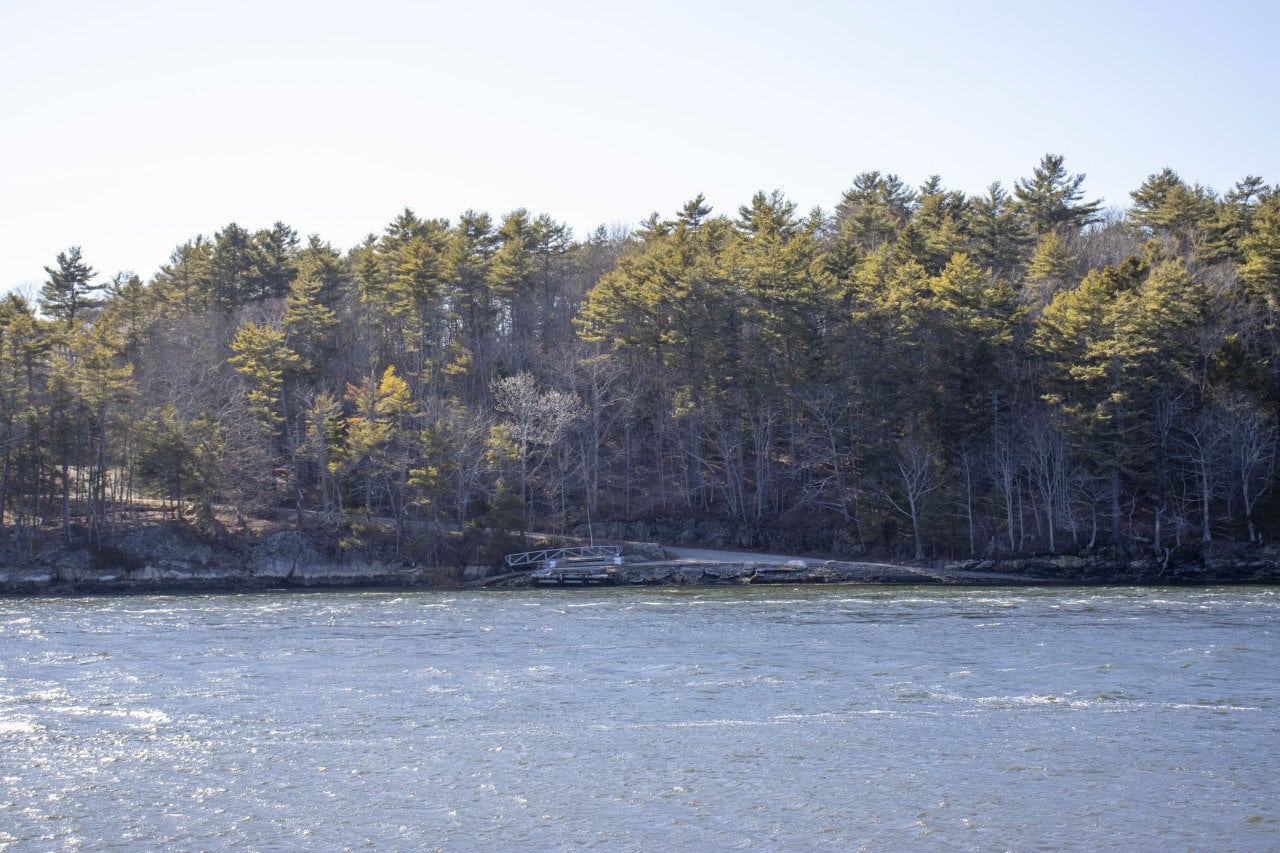 As seen from across the Back River in April of 2026, the 300-acre site where the idea for a data center was made public last fall remains undeveloped in Wiscasset, Maine.