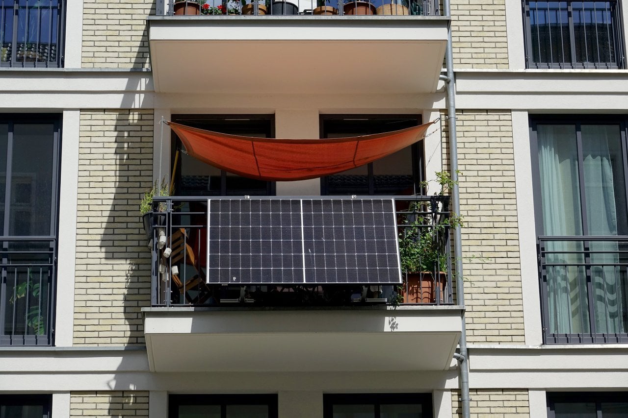A solar power station is attached to a balcony of a building.