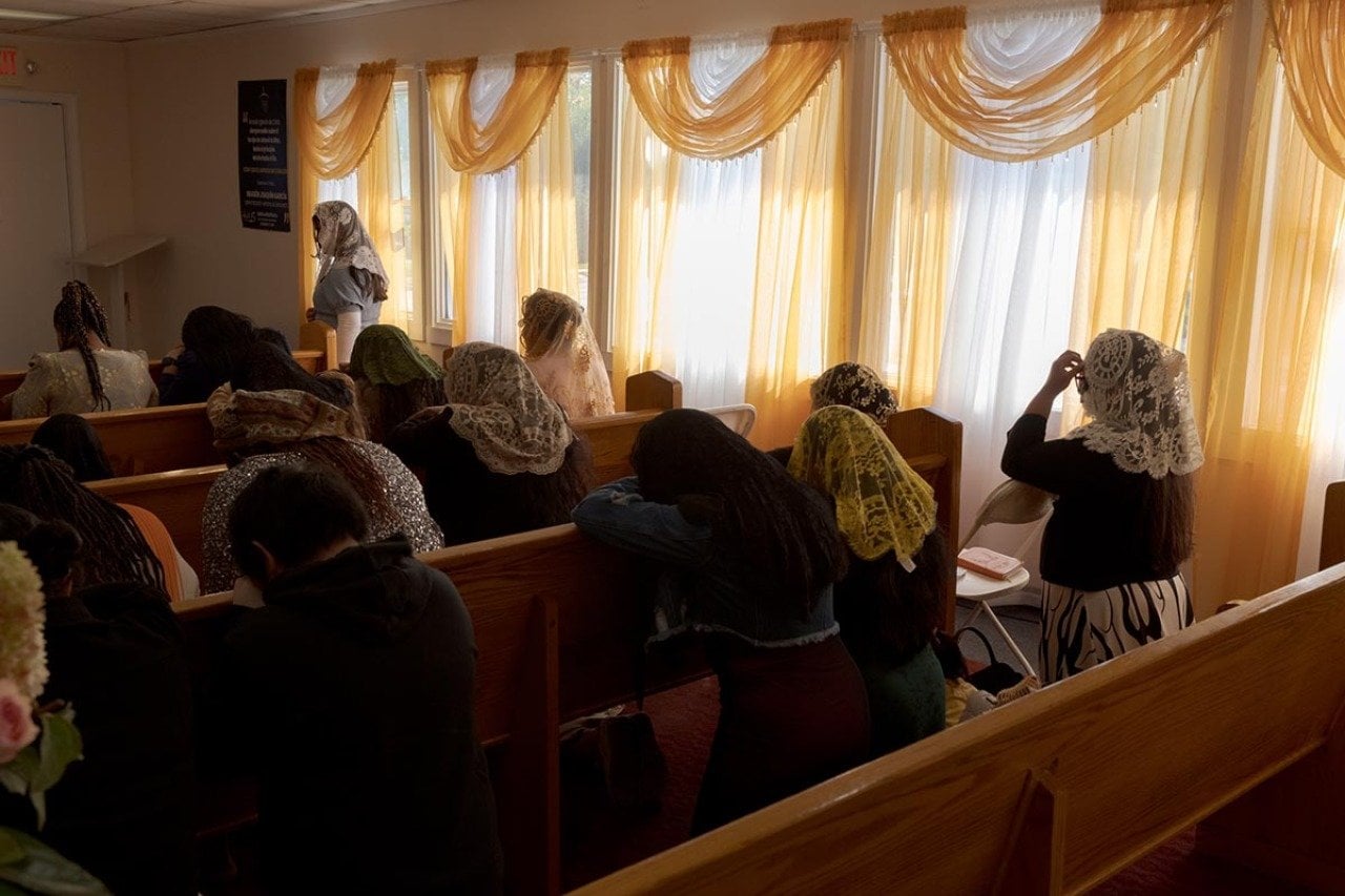 Parishioners in the women’s section pray at a Spanish-language church, which is attended by many farm workers, during a Sunday service in September.