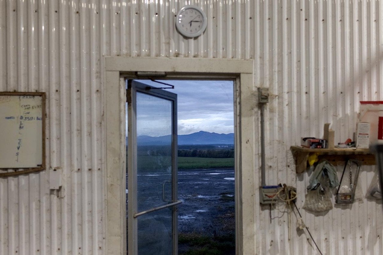 The Adirondack mountains visible through the doorway of the milk barn.