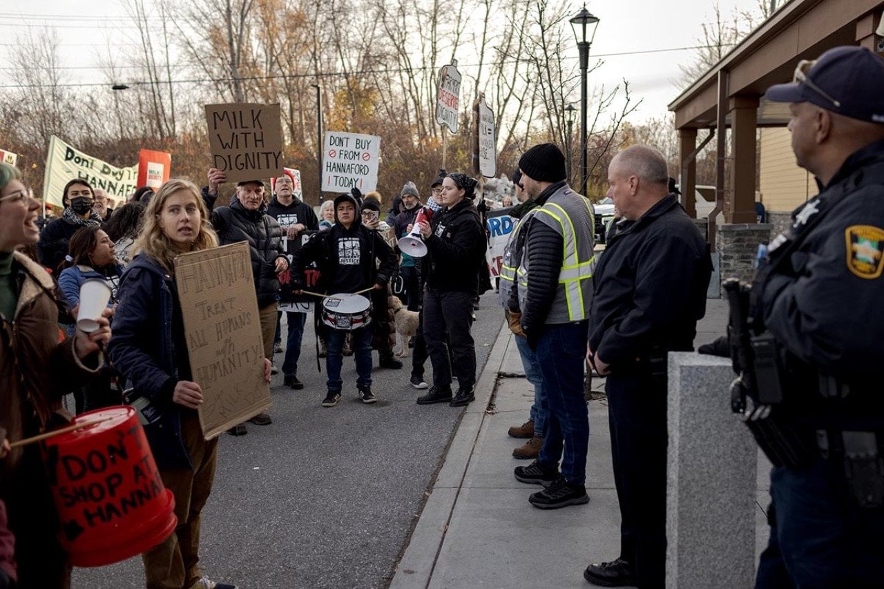 Workers, community members and activists with the Migrant Justice organization protest outside a Hannaford supermarket to call on the grocery store chain to join the Milk With Dignity program in November in South Burlington, Vermont.