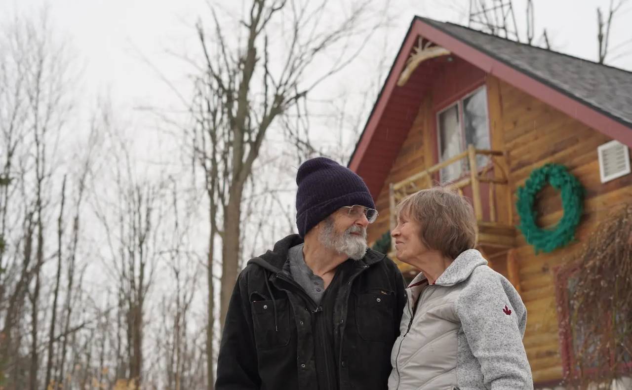 Wanda and Dave Whiting stand outside their home in Lewiston, Michigan.