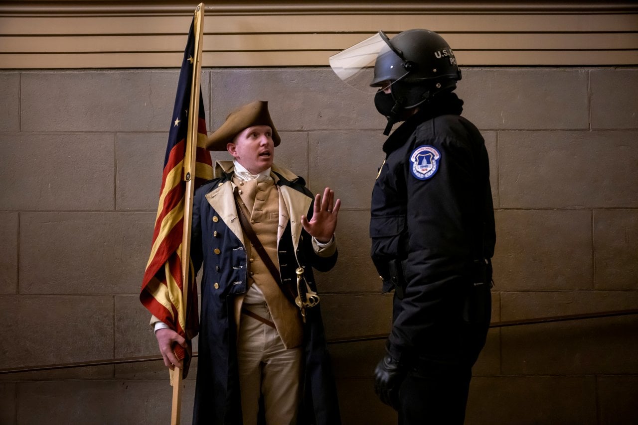 A protester dressed as George Washington debating with a Capitol Police inside the U.S. Capitol in Washington, DC.
