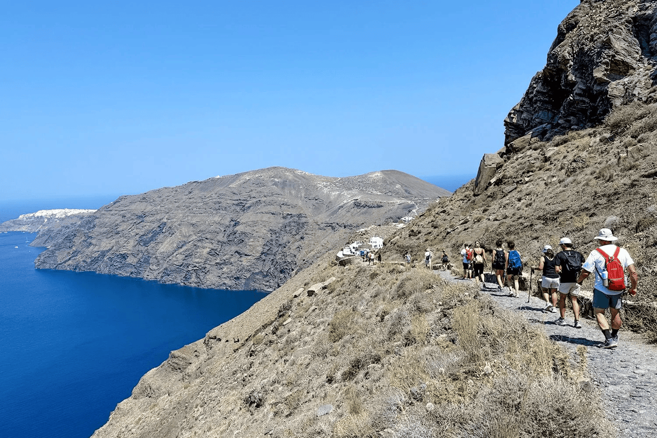 A view of a hiking trail along the Santorini caldera in Greece.