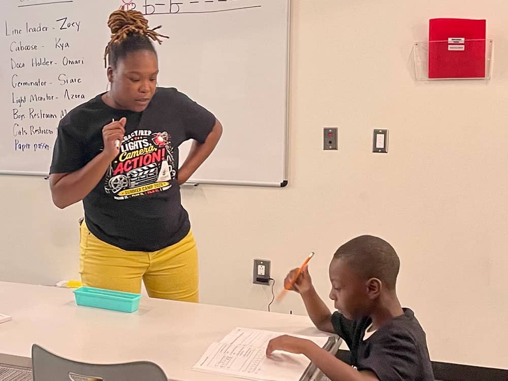 During a writing lesson, Legacy Prep teacher JaMeshia Moore gave a rising first grader some individual attention.