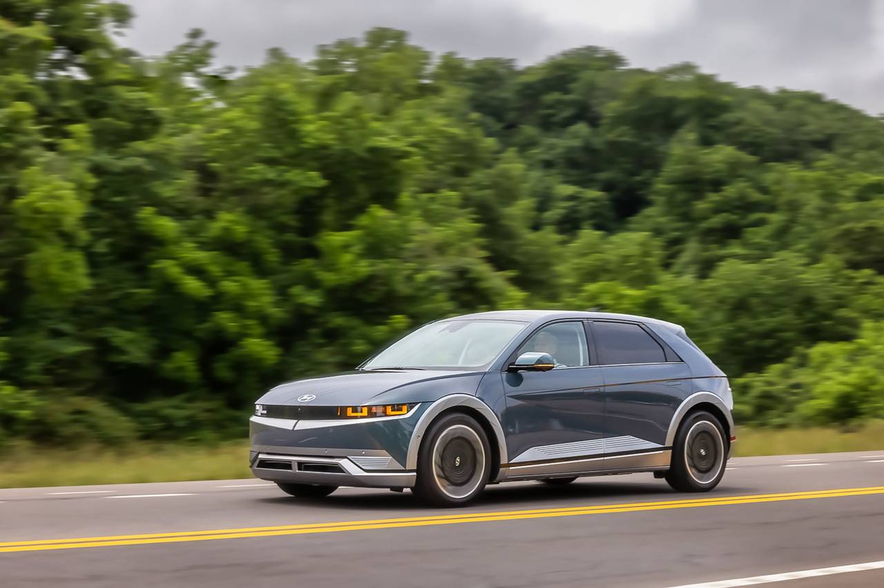 2024 Hyundai Ioniq 5 front three-quarter view driving on the road.