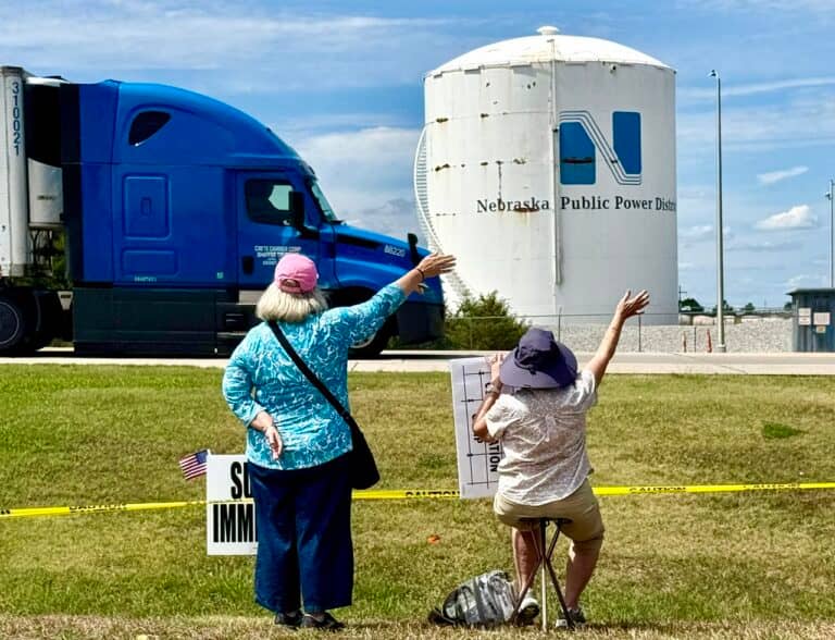 Demonstrators at the McCook immigration rally wave to traffic passing by on U.S. Highway 83.