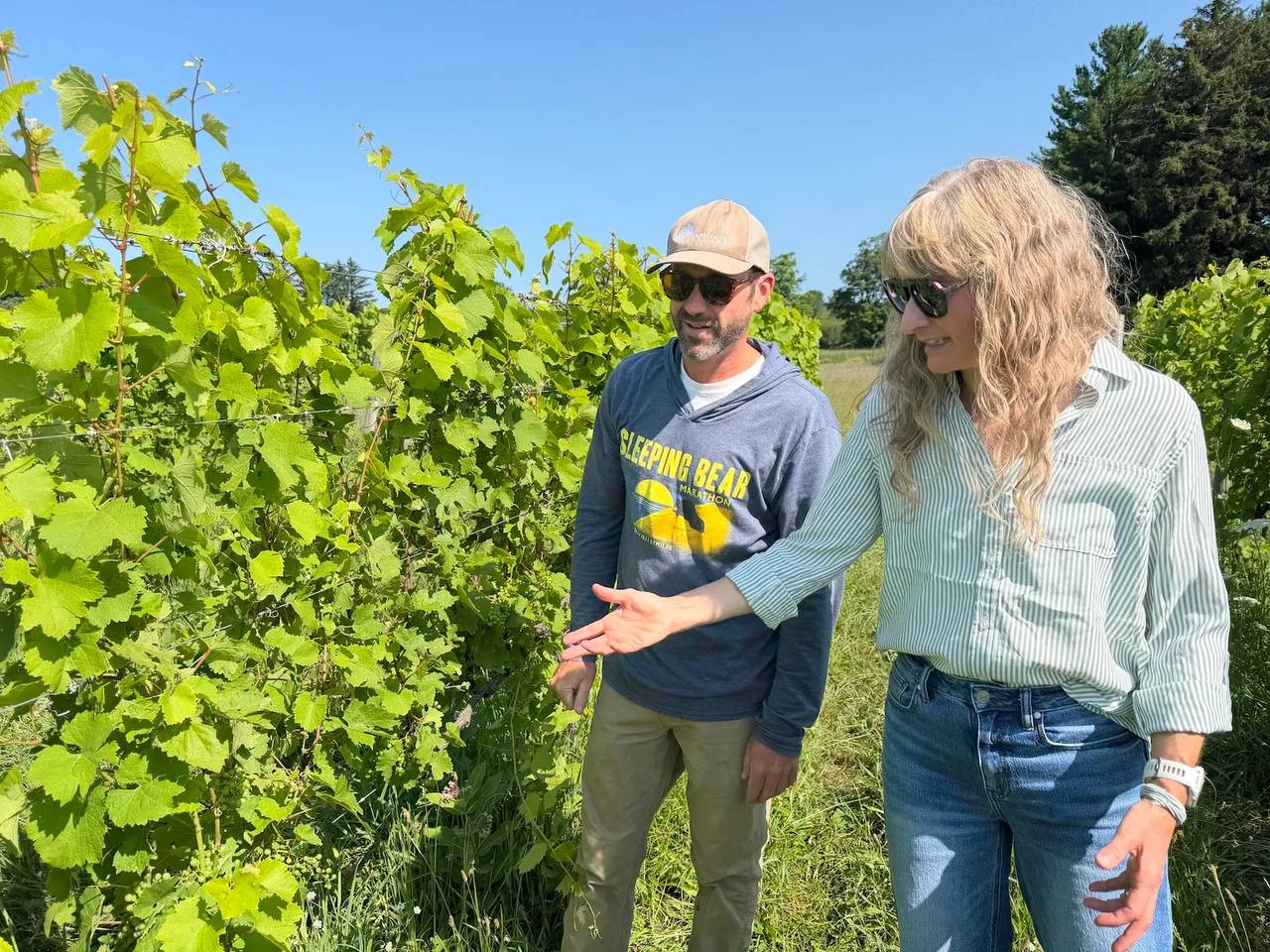 Vineyard manager Andy Fles, left, and Kasey Wierzba, general manager and executive winemaker, examine the grapevines at Shady Lane Cellars.