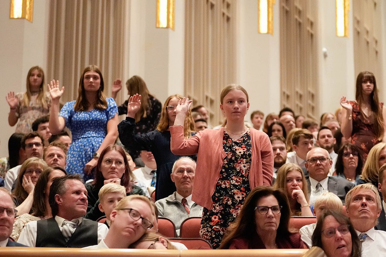 Young women stand to sustain Dallin H. Oaks as church president in April. Research shows young women are leaving the church in higher numbers.