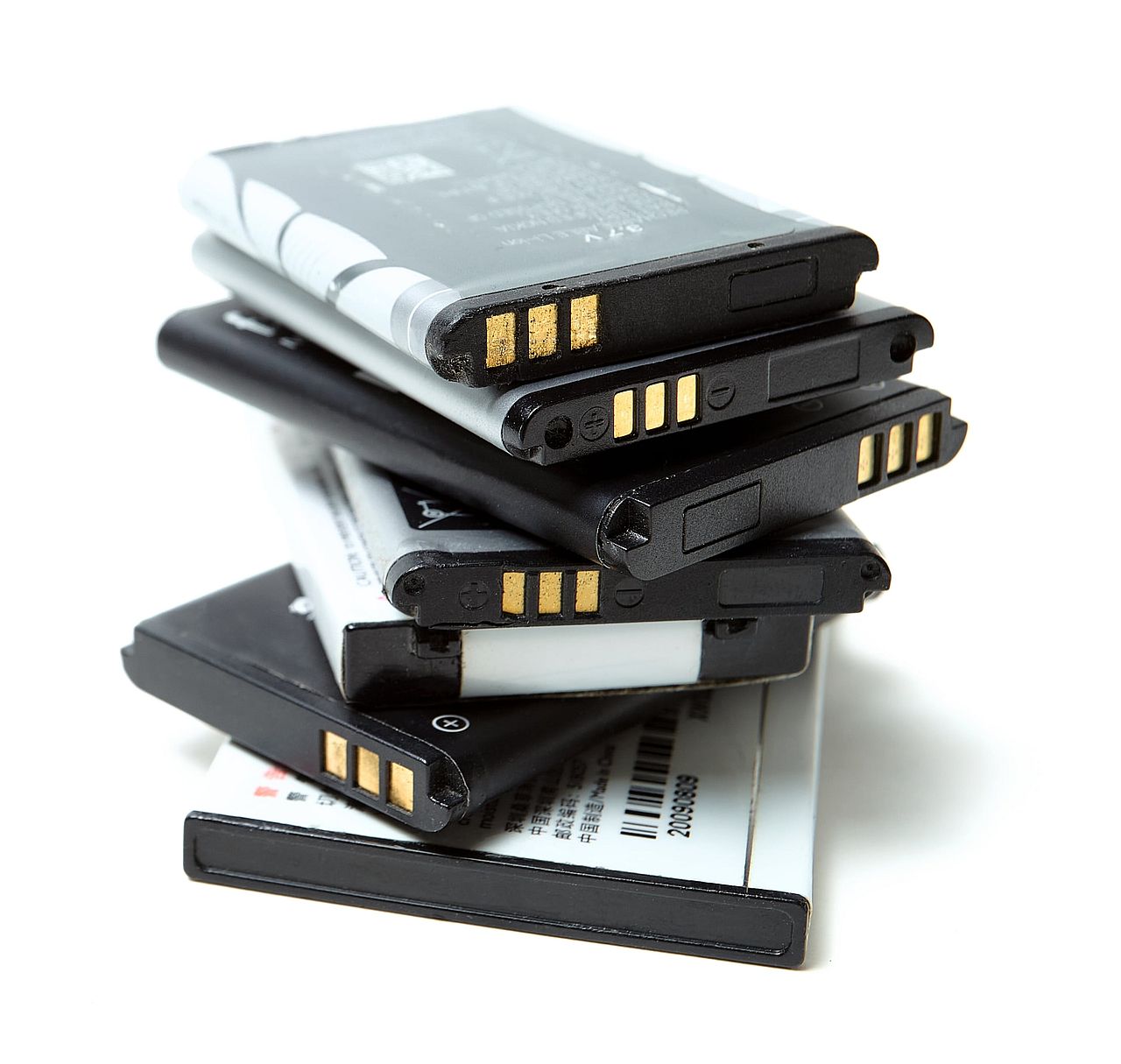 A pile of old and used lithium-ion batteries of older mobile phones.