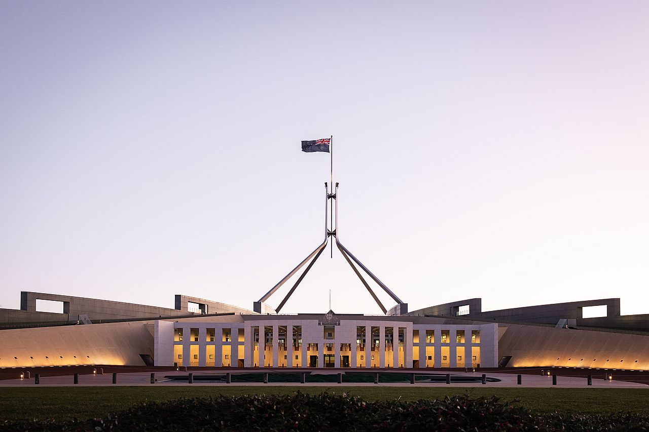 The Australian Parliament House at dusk.