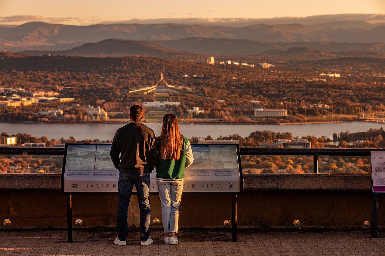 Two people looking out from the top of Mount Ainslie.
