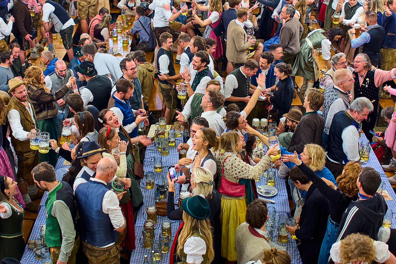 People celebrate at the Augustiner Brewery tent during the final day of Oktoberfest festival on October 5, 2025 in Munich, Germany.