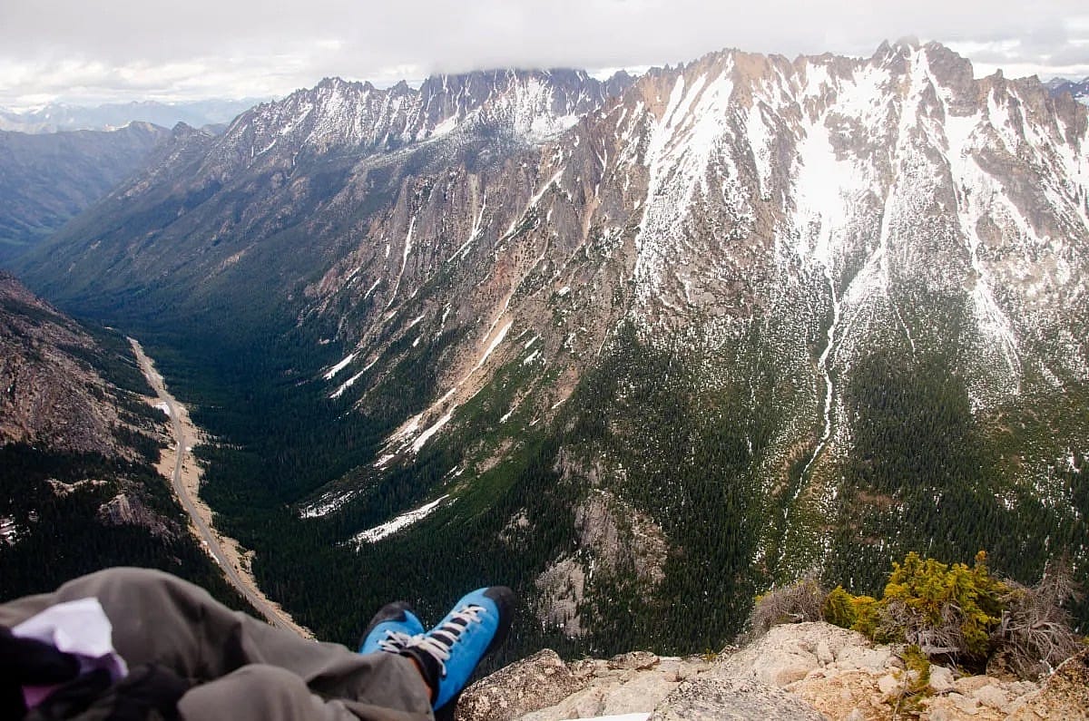 A climber sits on the summit of North Early Winter Spire in the North Cascades in Washington. Recreational activities like climbing are a big part of the economy of the Methow Valley, located a few miles down the road from this peak.