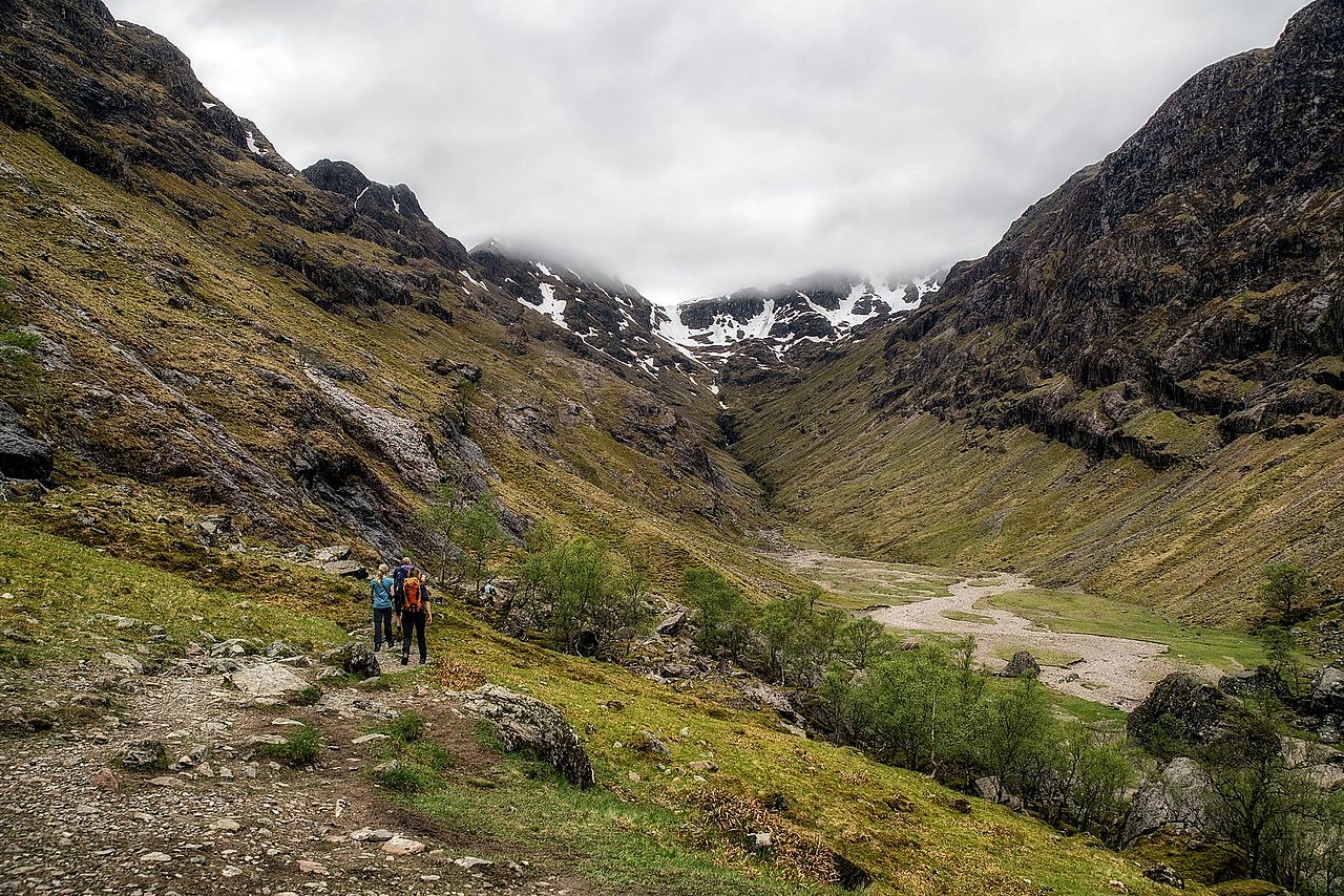 Hikers walking along the Lost Valley trail in Glen Coe, in the highlands of Scotland.
