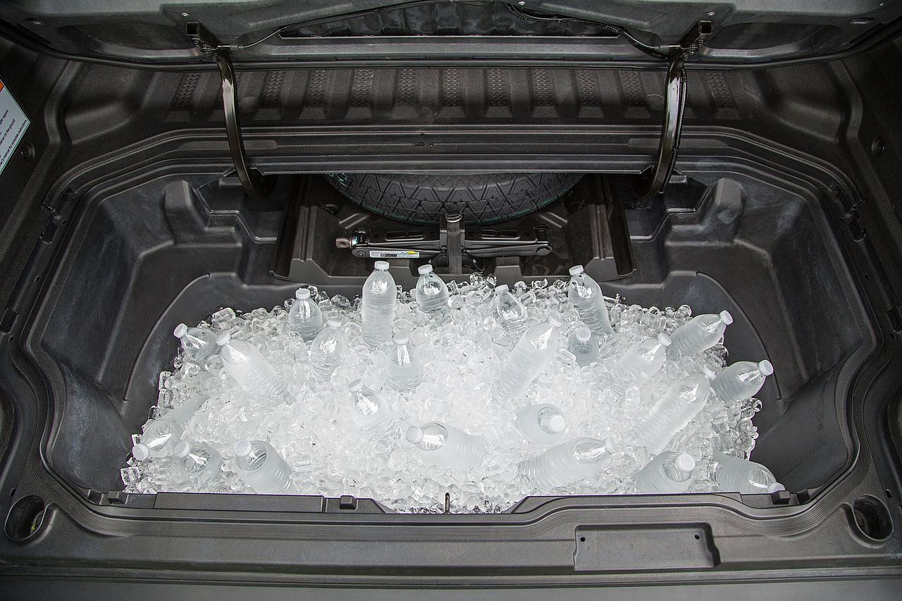 2026 Honda Ridgeline in-bed trunk filled with ice and bottles of water.