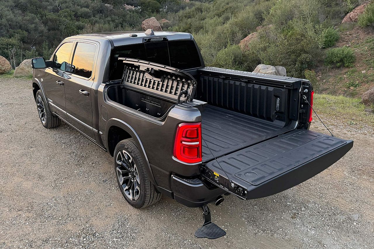 2026 Ram 1500 Limited in Granite Crystal showing the RamBox storage bins, cargo bed, and deployable step.