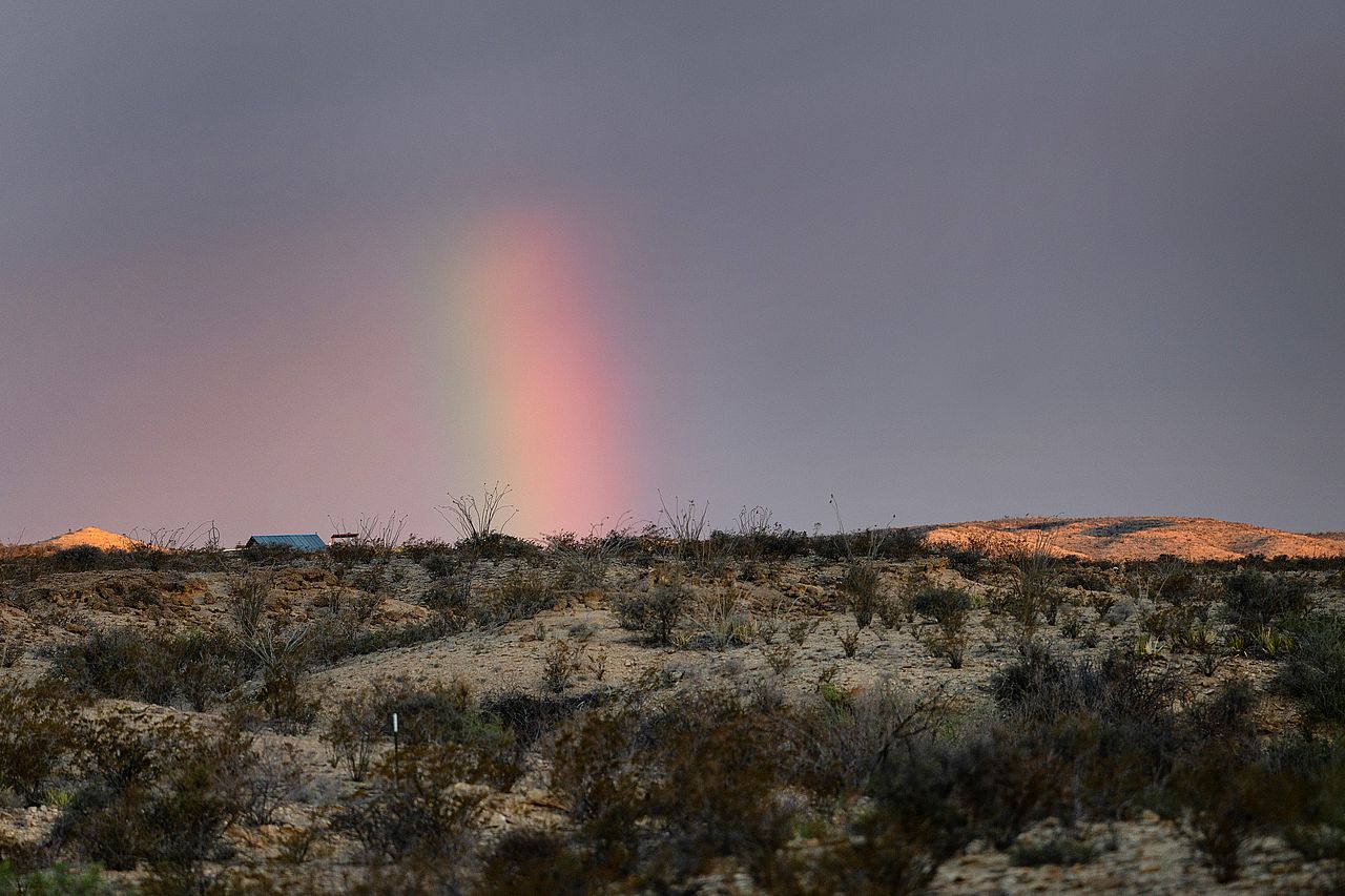 A rainbow forming after sunrise in Terlingua, Texas, USA.