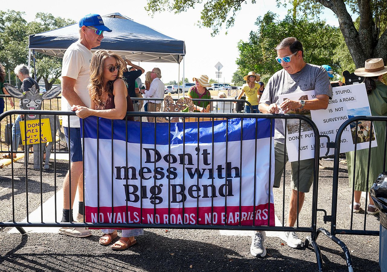 Jessica Bartko, of Terlingua, and Mark Resendez, of San Antonio, hanging a banner during a protest of border wall construction in the Big Bend region outside Texas Parks and Wildlife Department headquarters in Austin, Texas, USA.